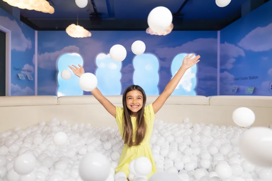 A man and two children stand in the center of an immersion
